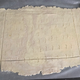 Rolled out puff pastry, with fork pricks and clean edges scored into the rough edges